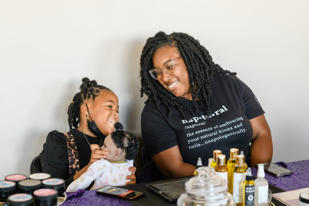 It's a family affair! LaShesia Holliday, founder of Naptural Beauty Supply, brought her daughter to help sell at the pop-up market.